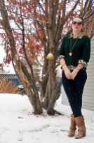 cable knit sweater over printed button down with skinny jeans tucked into boots